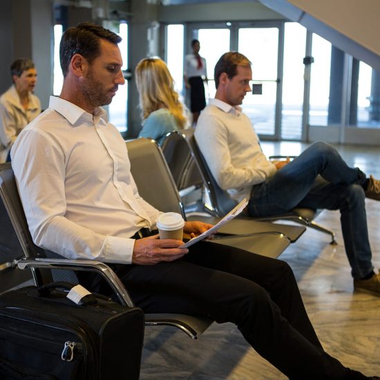 businessman-reading-newspaper-waiting-area