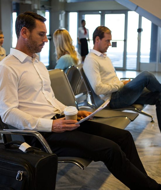 businessman-reading-newspaper-waiting-area